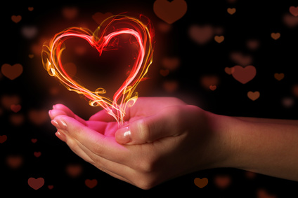 Hands with heart-shaped smoke isolated on black